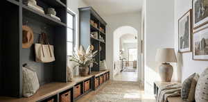 Mudroom with arched walkways and healthy amount of natural light
