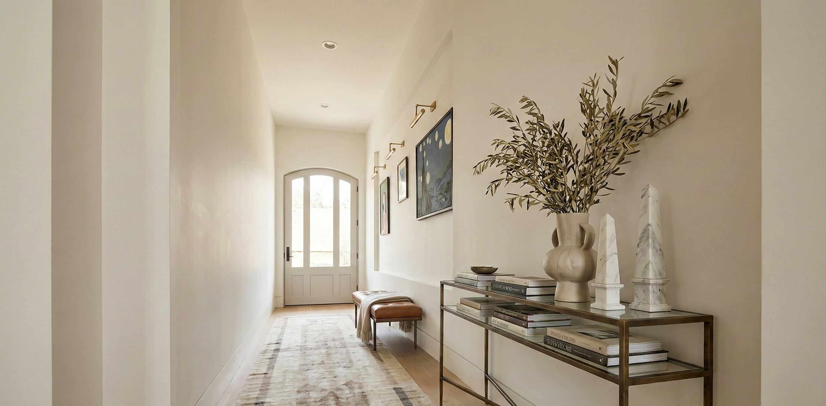 Hall with arched walkways and wood finished floors