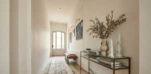 Hall with arched walkways and wood finished floors