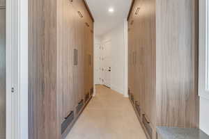 Hall with recessed lighting and concrete floors