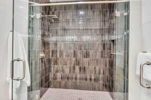 Full bathroom featuring a shower stall
