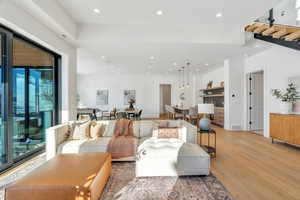 Living area with wood finished floors and recessed lighting
