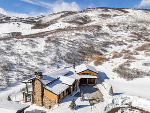 Snowy aerial view featuring a mountain view