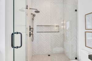 Full bathroom featuring toilet and a shower stall