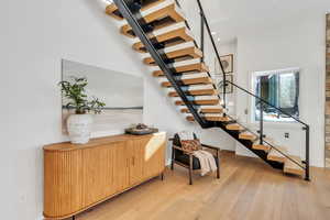 Stairway featuring hardwood / wood-style flooring and baseboards