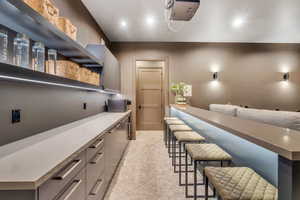 Bar with open shelves, modern cabinets, stainless steel microwave, recessed lighting, and gray cabinets
