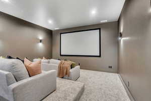 Carpeted cinema room featuring recessed lighting and baseboards