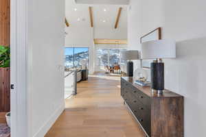 Corridor with light wood finished floors and recessed lighting