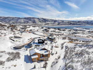 Snowy aerial view with a mountain view and a residential view
