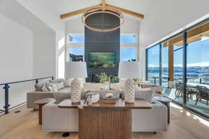 Living room with a mountain view, hardwood / wood-style floors, and vaulted ceiling