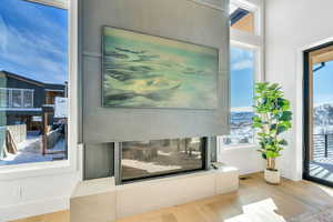 Detailed view of a multi sided fireplace and wood finished floors