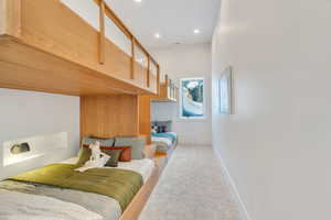 Carpeted bedroom with baseboards and recessed lighting