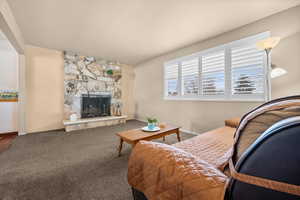 Carpeted living area with a fireplace