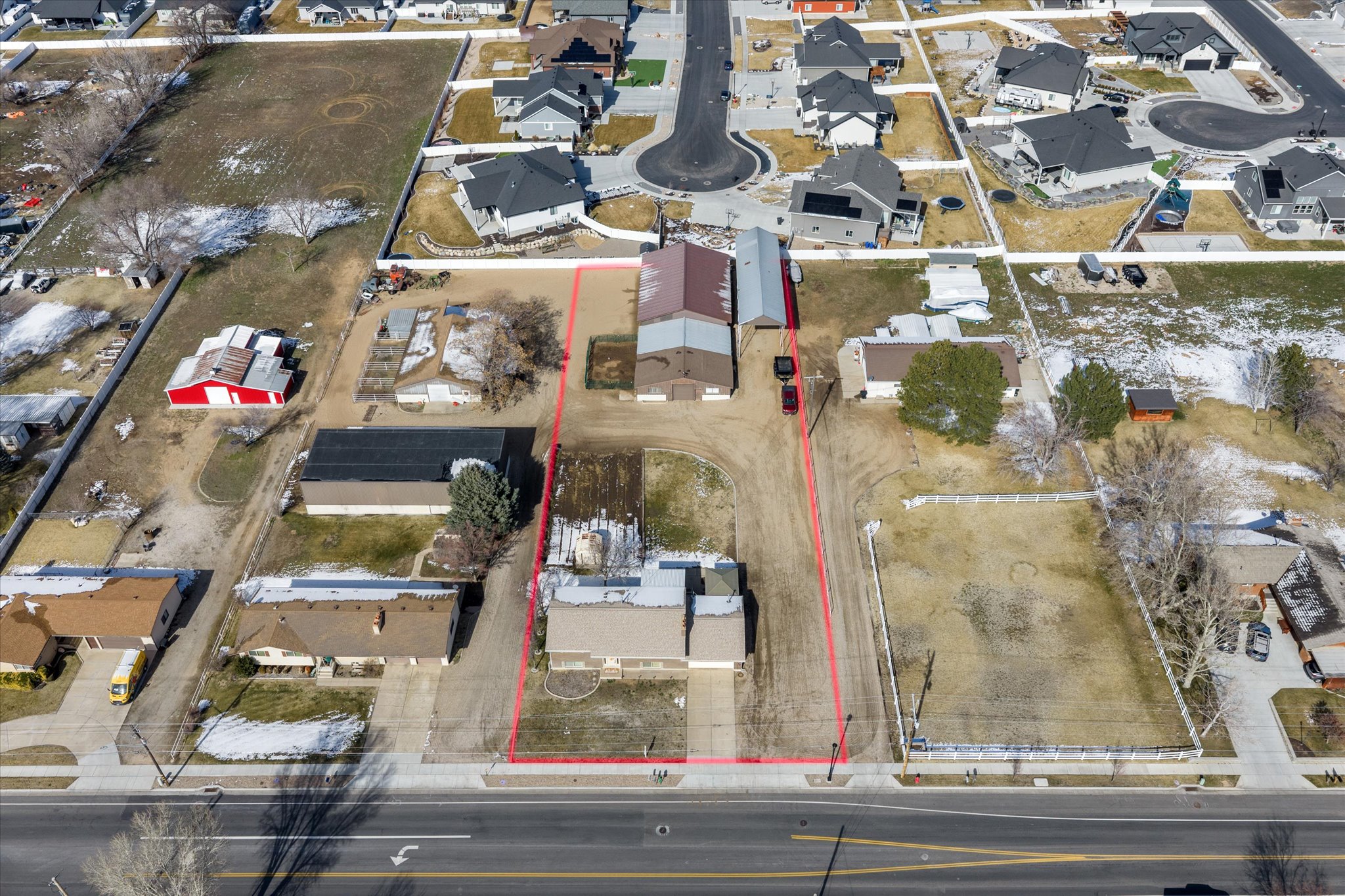 Aerial view of residential area featuring property boundaries highlighted