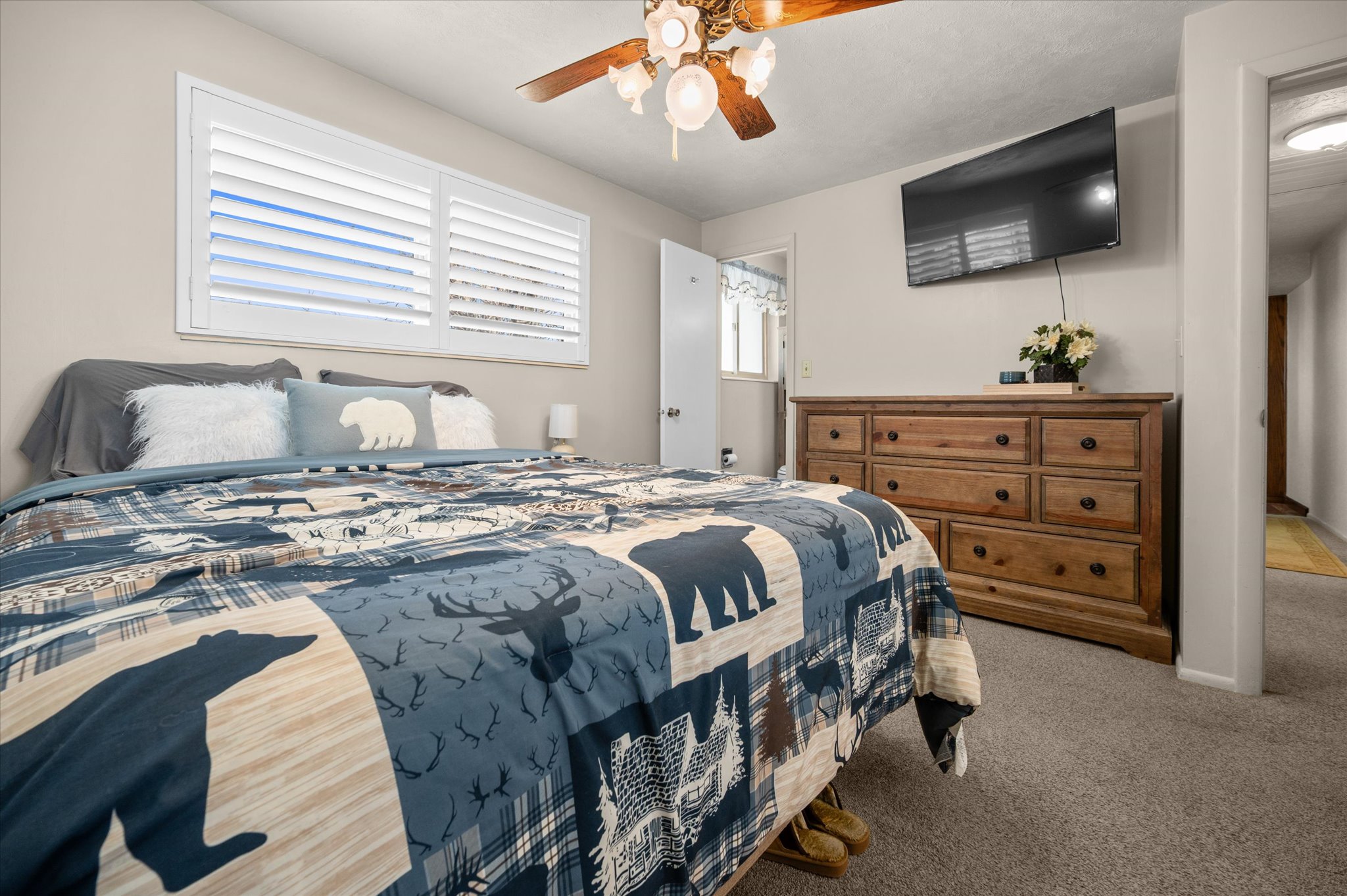 Bedroom with light carpet and ceiling fan