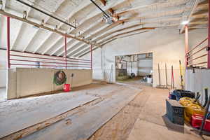 Miscellaneous room featuring a garage and vaulted ceiling