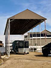 View of parking with a carport