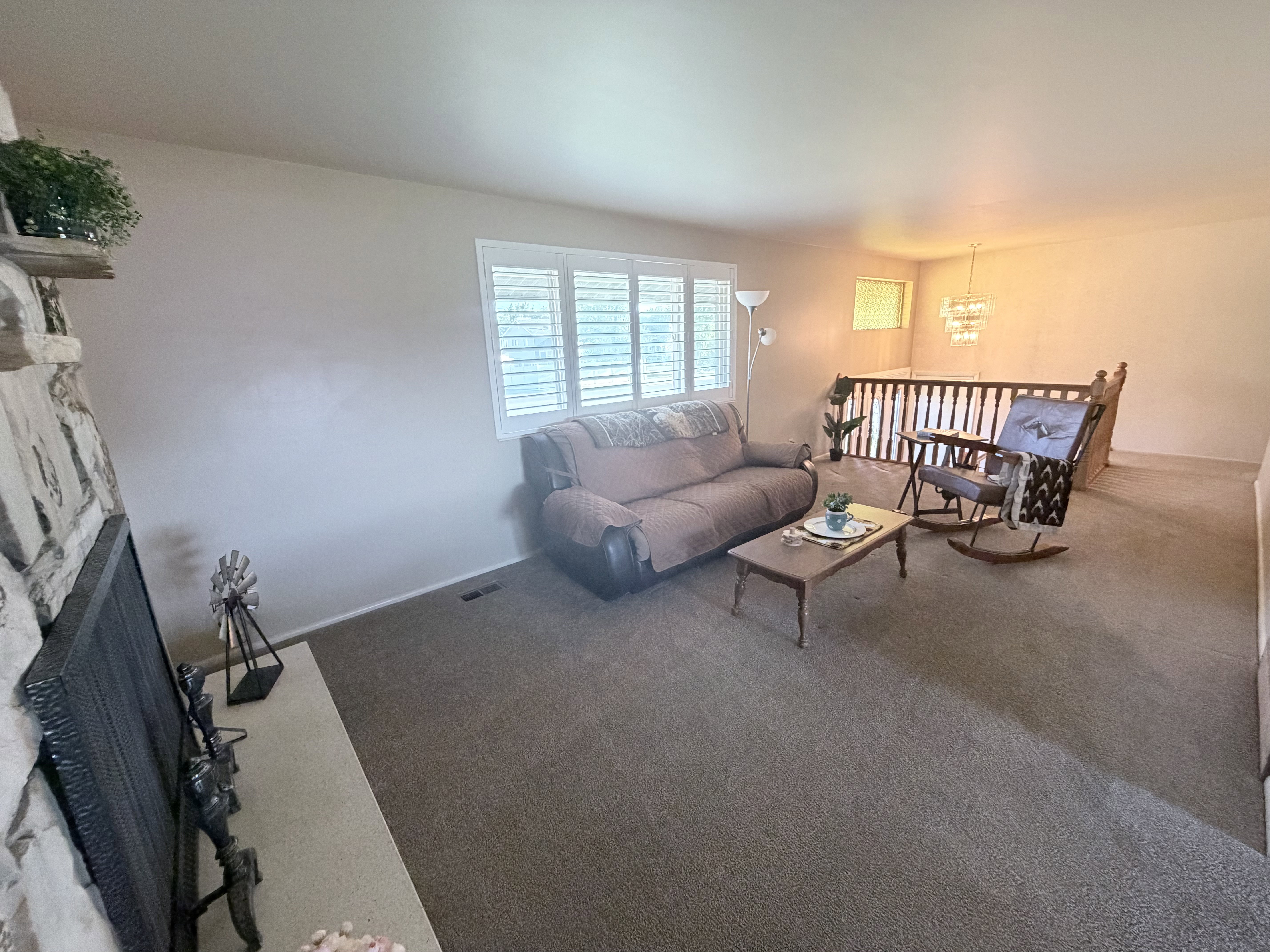 Living space featuring neutral wall tones and plush carpeting