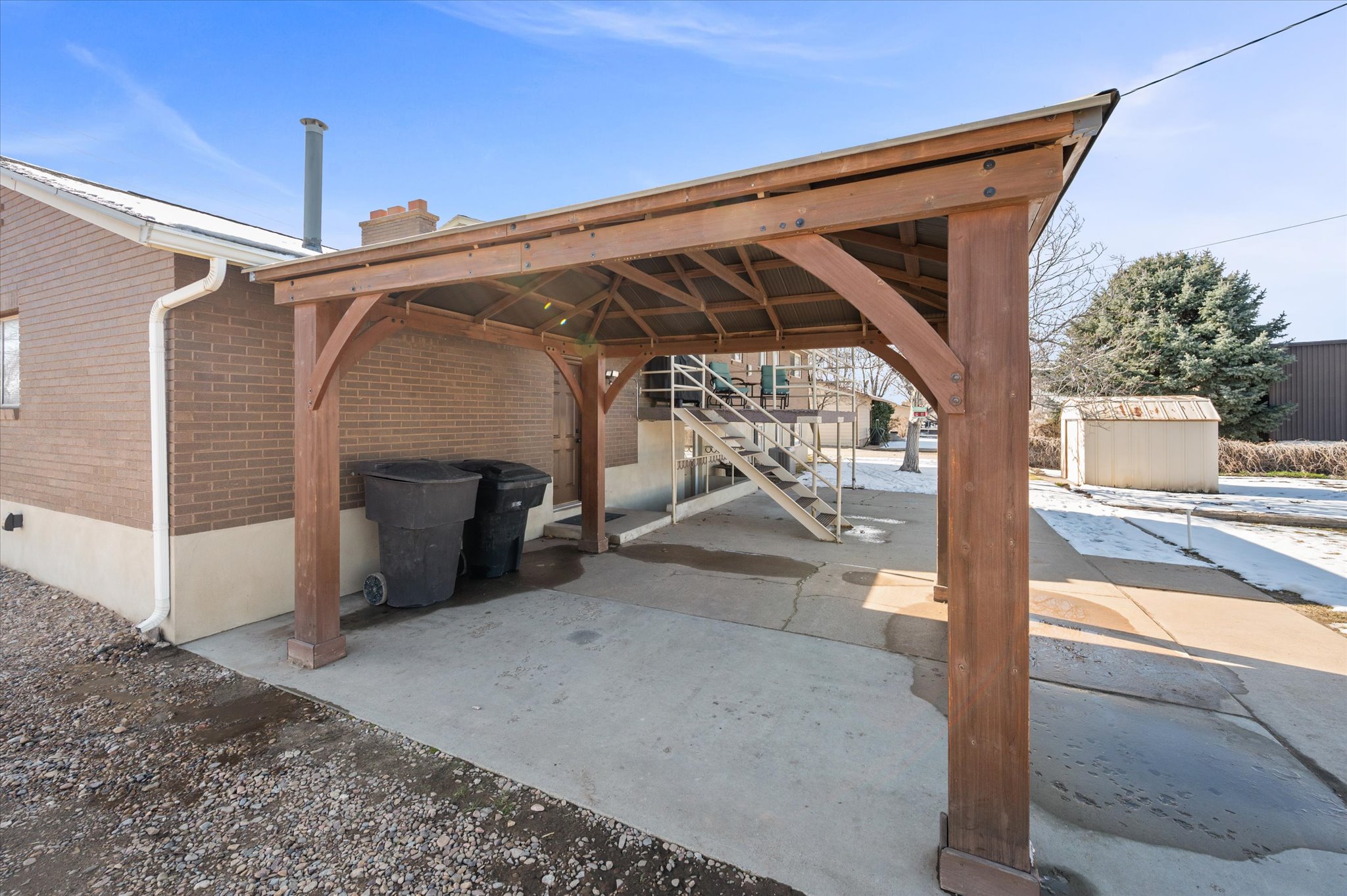 View of patio with a shed