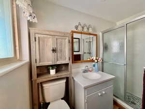 Full bath with vanity and a stall shower off of owner's bedroom