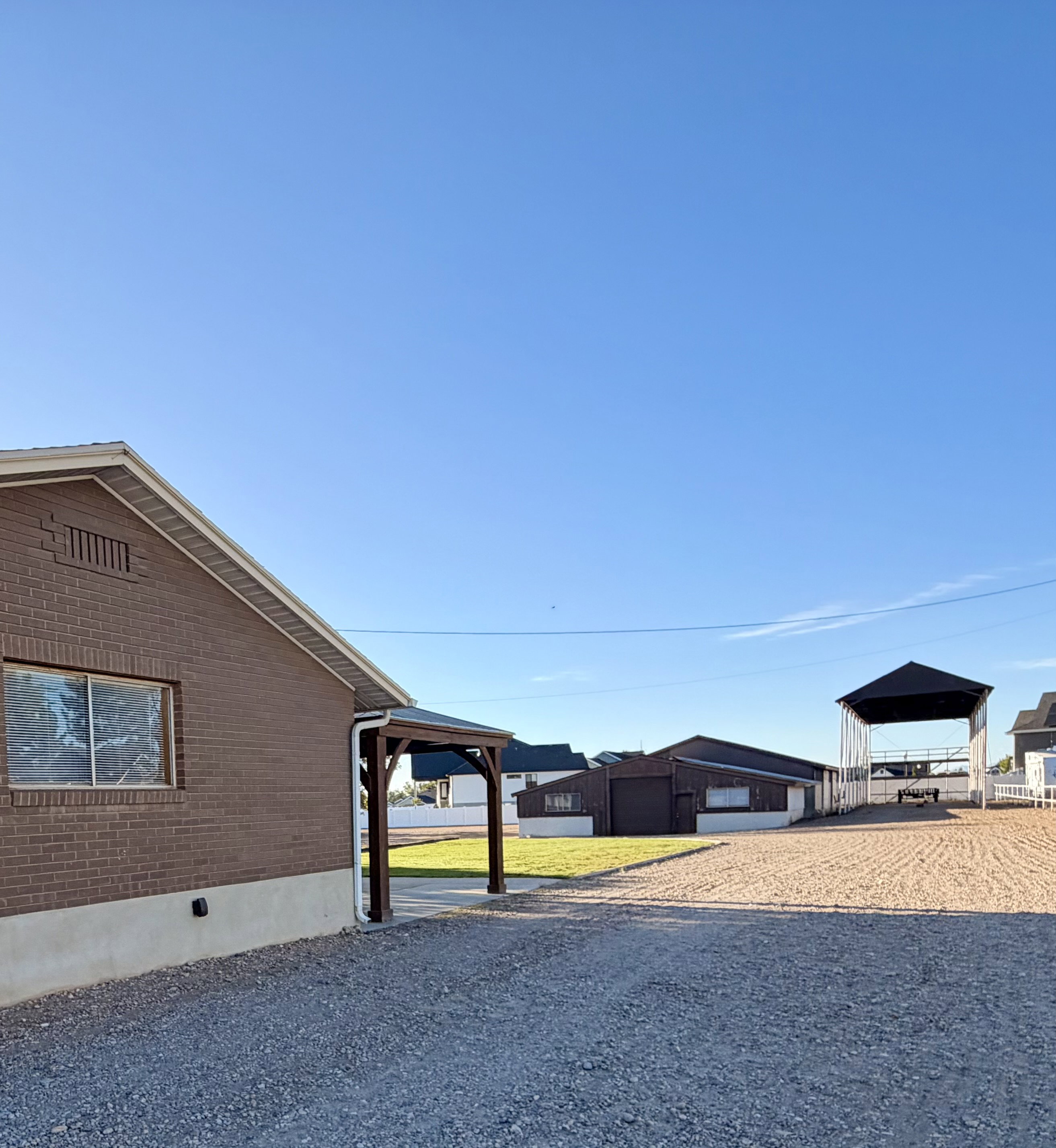 Brick exterior with a covered entryway and gravel driveway