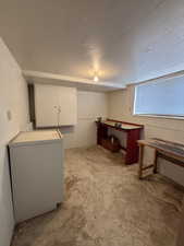 Below grade area with a textured ceiling