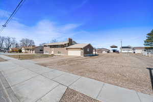 View of yard with a residential view, concrete driveway, and a garage