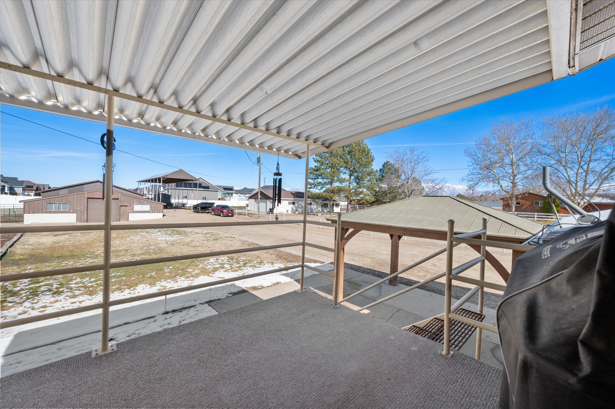 View of patio with a residential view and area for grilling