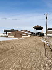 View of yard with an outdoor structure and a detached carport