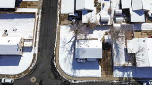 Snowy aerial view with a residential view