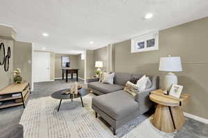 Basement living room has plenty of space for lounging and a basement office or game area.