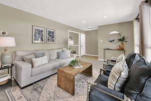 Living room featuring carpet flooring and recessed lighting