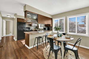Dining room with baseboards and dark wood-type flooring
