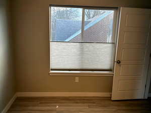 Empty room with baseboards and wood finished floors