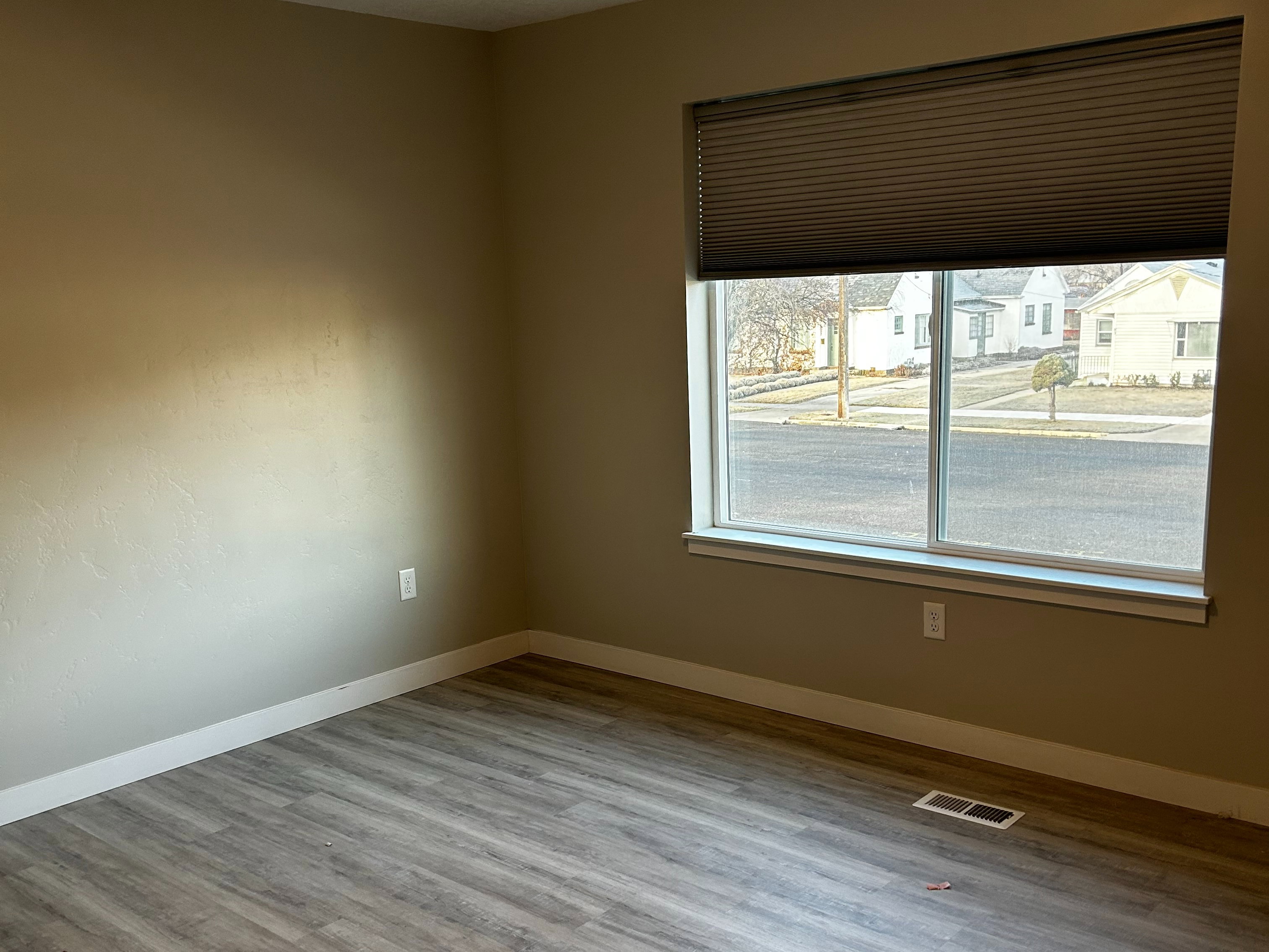 Unfurnished room featuring wood finished floors and a textured ceiling