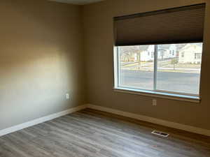 Unfurnished room featuring wood finished floors and a textured ceiling