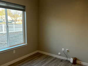 Empty room featuring wood finished floors and a residential view