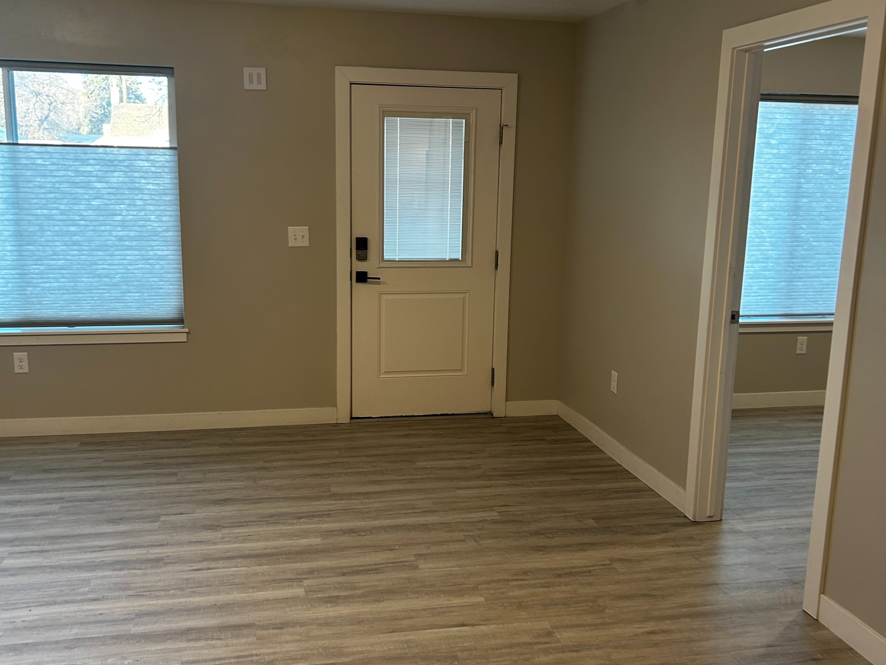 Foyer with a textured ceiling and wood finished floors
