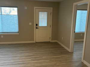 Foyer with a textured ceiling and wood finished floors