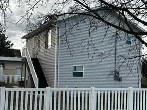 View of side of home with a fenced front yard