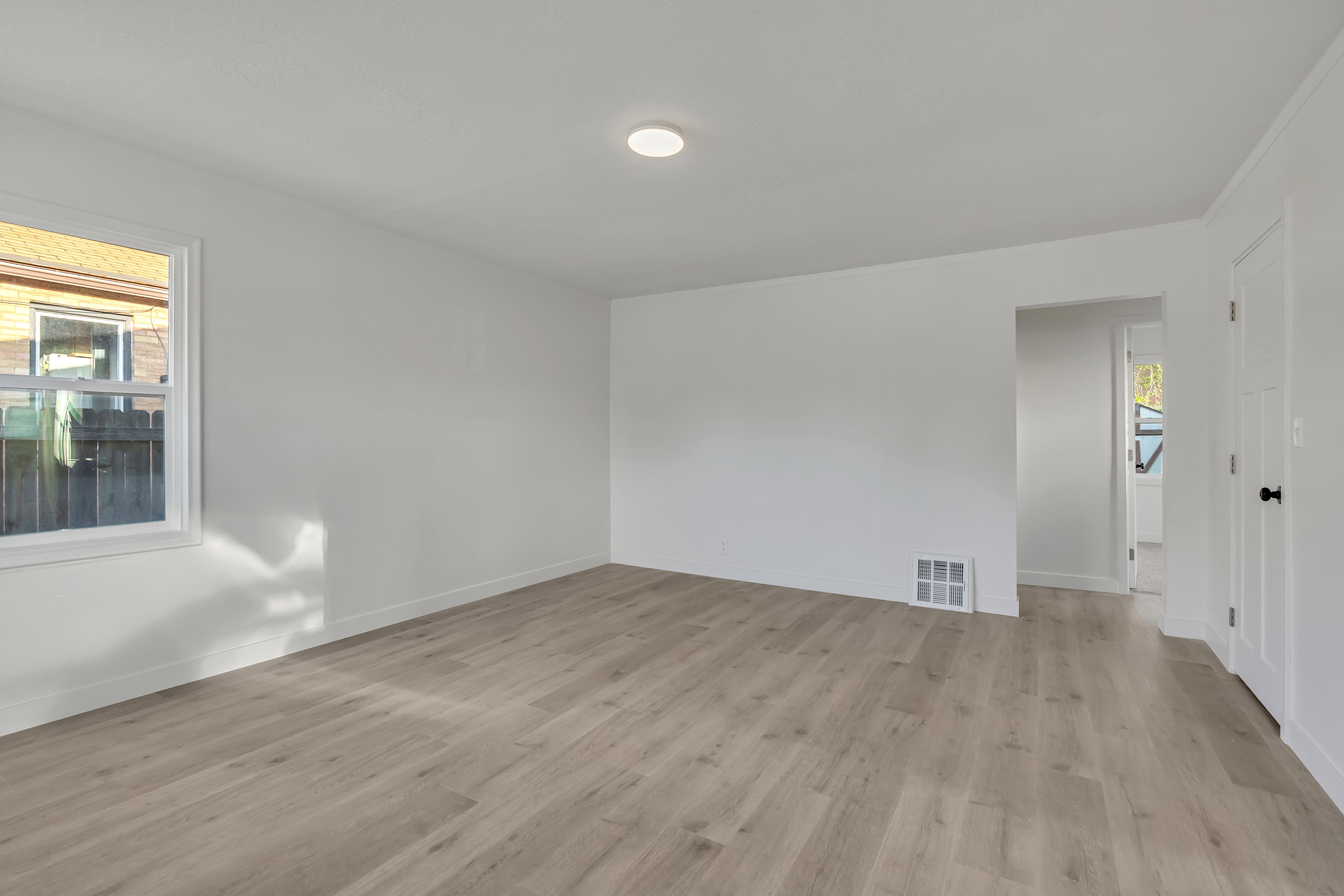 Unfurnished room featuring light wood-type flooring and baseboards