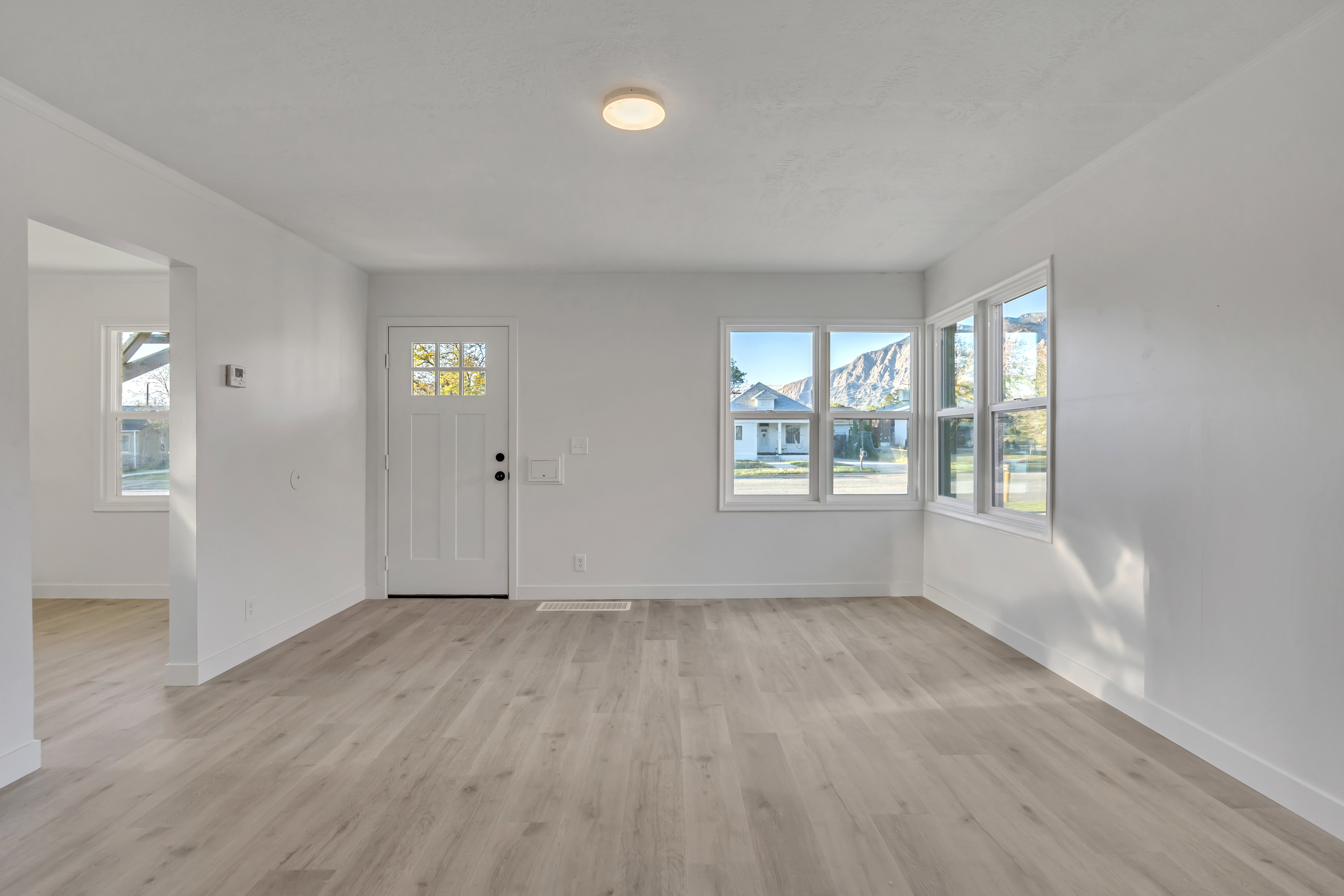 Foyer entrance featuring light wood-style flooring and healthy amount of natural light