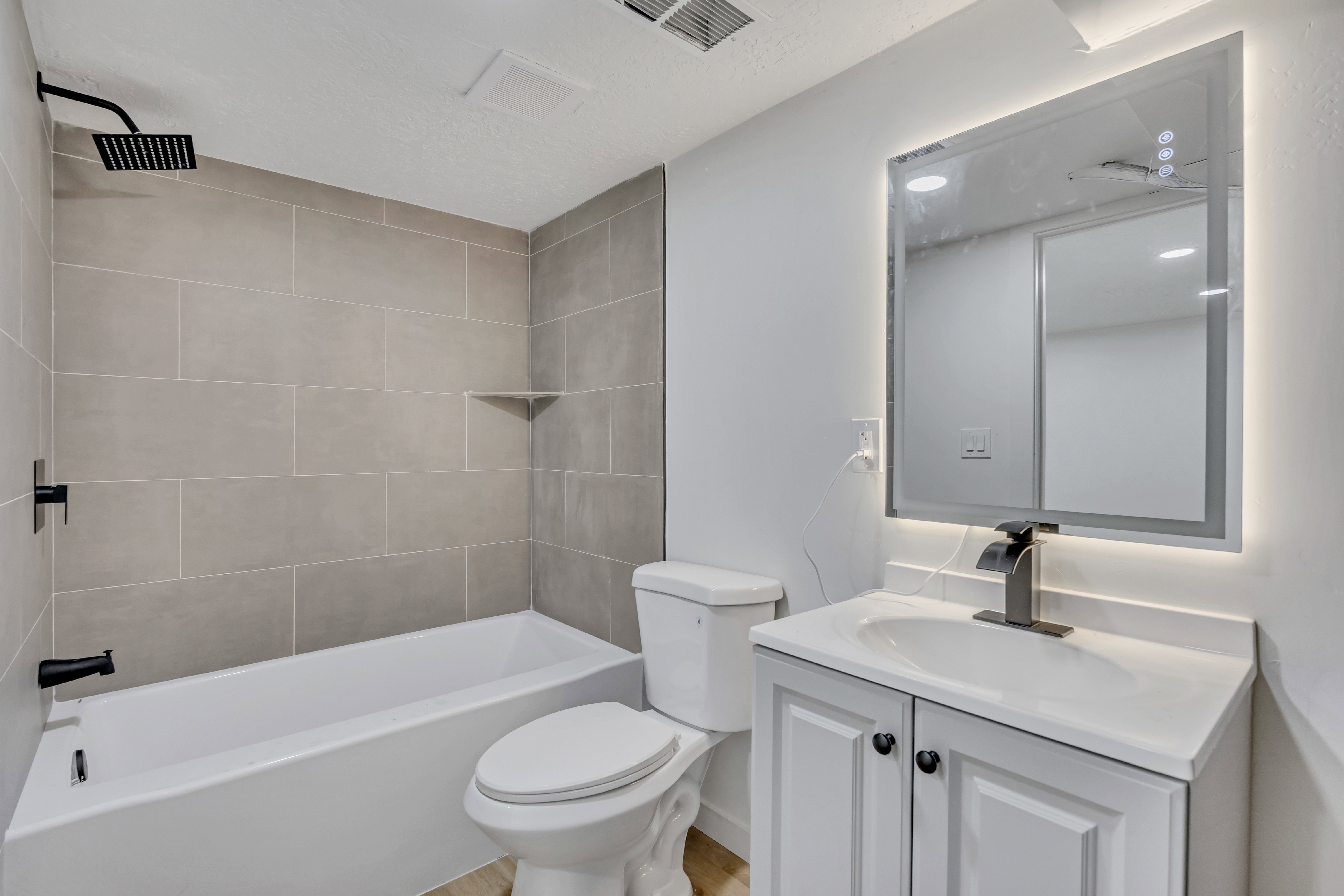 Bathroom with vanity and shower / bath combination