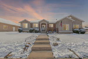 View of front of property with brick siding and stucco siding