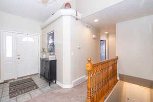 Carpeted foyer featuring baseboards and recessed lighting