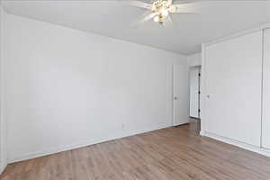 Bedroom with a ceiling fan and wood finished floors