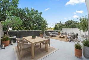 View of patio / terrace featuring an outdoor living / dining area, Virtually staged