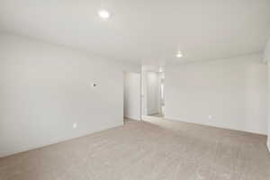 Spare room featuring light carpet and recessed lighting