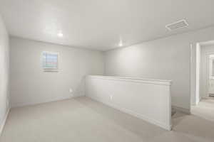 **DISCLAIMER** Interior package & colors may vary. Spare room with light colored carpet and recessed lighting
