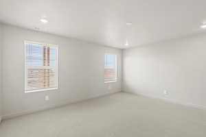**DISCLAIMER** Interior package & colors may vary. Unfurnished room with light colored carpet and recessed lighting